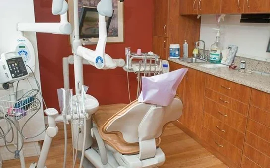 An exam chair and dental exam equipment inside an exam room at Dental Implant Center NYC