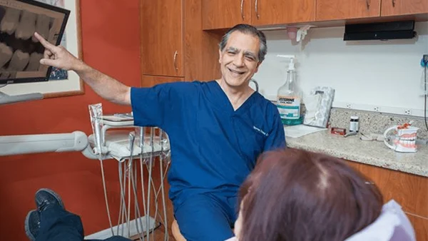 Dr. Spyridon Condos and a patient discussing her teeth x-rays